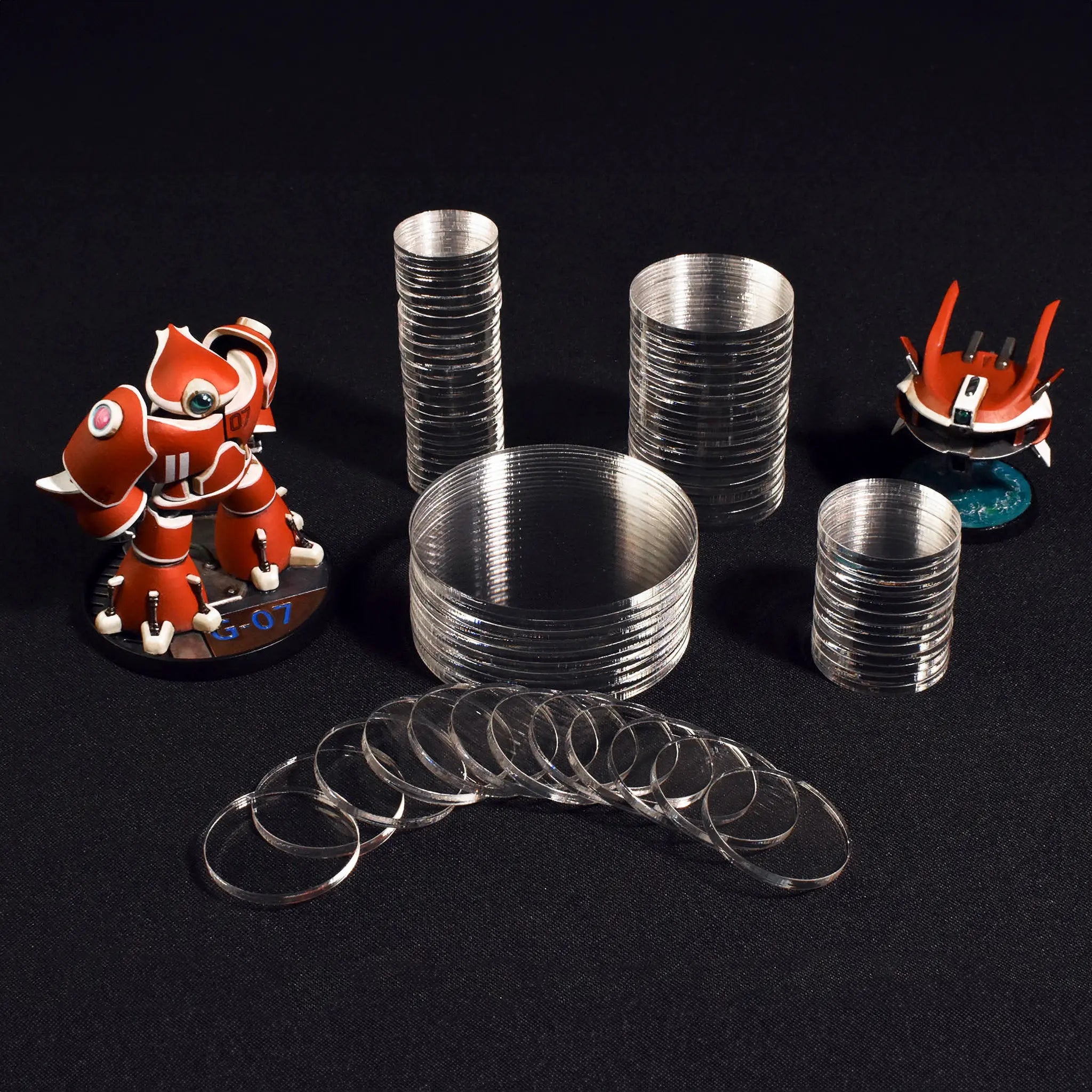 Crystal Fortress miniature bases stacked with Big Red. Premium quality bases for secure and organized miniature display.