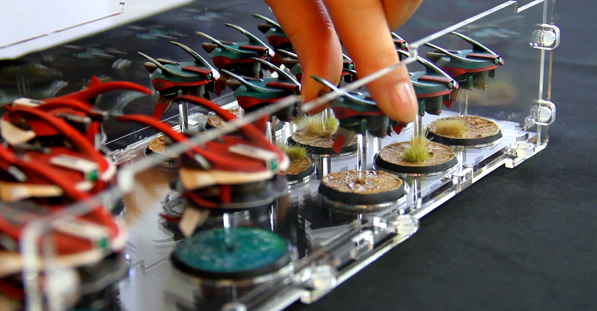 placing miniature into acrylic case